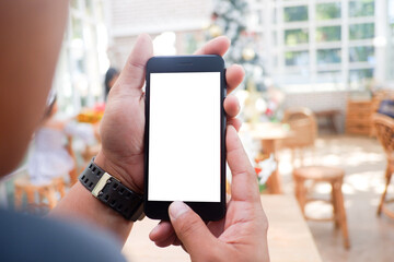 Mockup picture of business man's hands holding smart phone with white blank screen in modern place.