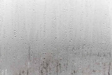 Close up for misted glass with droplets of water draining down. Dripping Condensation, Water Drops Background Rain drop Condensation Texture