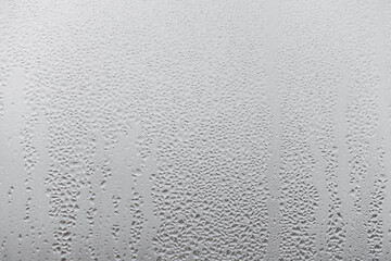 Close up for misted glass with droplets of water draining down. Dripping Condensation, Water Drops Background Rain drop Condensation Texture