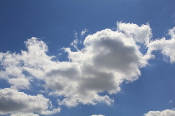 The clouds in the blue sky create fabulous figures that live their own lives, constantly changing and running away from us. A fairy tale that can be seen in the sky.