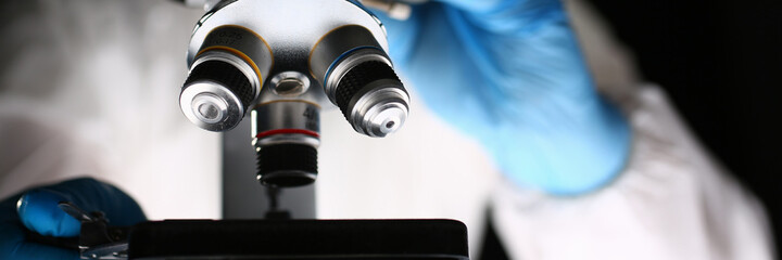 Professional scientist using equipment in modern laboratory while examining new chemical formula