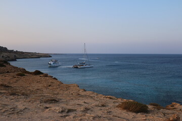 the national Park of Cape Greco, Cyprus blue lagoon, boats, sunset