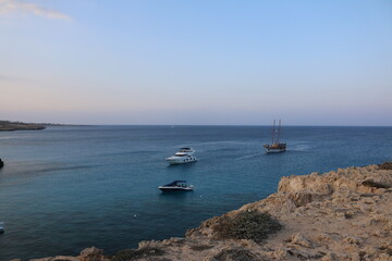 the national Park of Cape Greco, Cyprus blue lagoon, boats, sunset