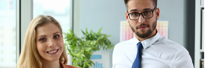 Handsome bearded man holding folder while standing near his partner, going to start meeting