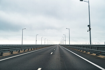 Empty highway with asphalt road and cloudy sky