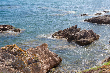 rock cliff top view with drone by the sea