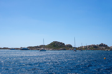 Naklejka premium view of boat in the open sea, calm and blue in the Mediterranean between France and Italy for a peaceful, calm and zen vacation