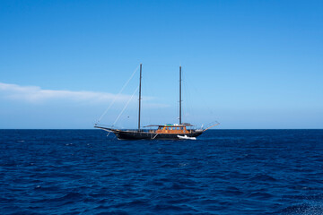 view of boat in the open sea, calm and blue in the Mediterranean between France and Italy for a peaceful, calm and zen vacation