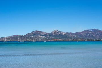 Calvi beach in summer view of the turquoise blue sea with the motagne in the background