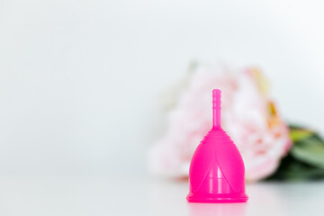 Menstrual cup and flower bud close up