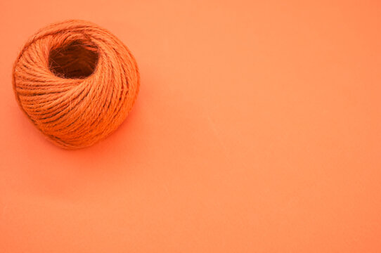 Orange Yarn Ball For Knitting Isolated On Orange Background