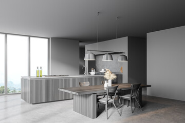 Gray and wooden kitchen corner with table and window