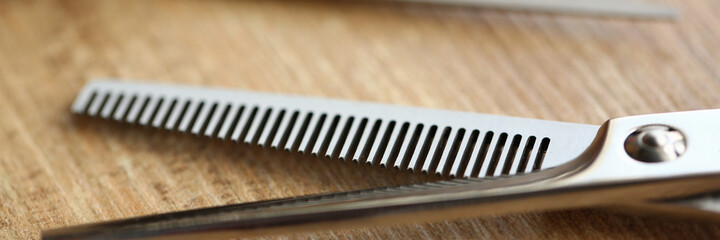 Macro picture of hairdressing scissors that lying on the table, being used for stylish haircut