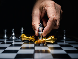 Human hand moving king chess piece at table