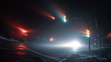 Thick fog over empty road with traffic light