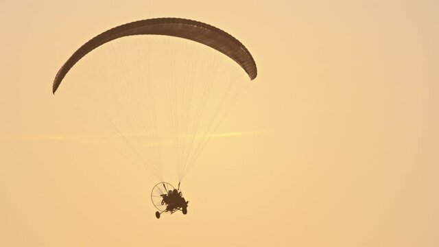 Paramotor Tandem Gliding And Flying In The Air. Copy space. High quality 4k footage