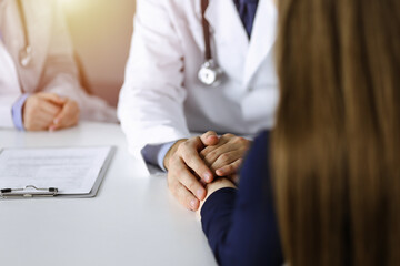 Unknown man-doctor reassuring his female patient, close-up. Perfect medical service, empathy in...