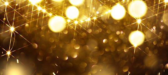 Christmas glowing golden background. Golden Holiday Abstract Glitter Defocused Backdrop With...