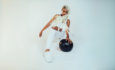 African american female athlete working out using medicine ball