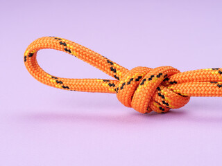 Poacher’s Knot on a pastel purple background