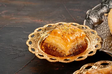 Tuinposter Piece of Turkish baklava in golden arabic plate © fotofabrika