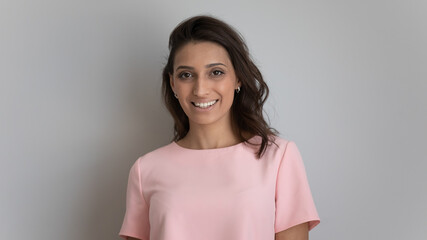Head shot portrait of happy young arabic indian multiracial ethnicity beautiful woman with healthy shiny gloss hair and white toothy smile looking at camera, isolated on grey white studio background. - Powered by Adobe