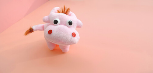 Cute soft pink bull figurine.  New Year greeting card with free copy space for text. Chinese Year of Bull, Zodiac symbol 2021   
