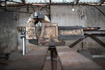 Large iron vise on the table