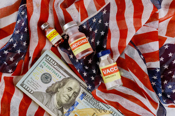 American vaccine coronavirus SARS-COV-2 COVID-19 to fight in the coronavirus pandemic with the US dollar currency USA flag in the background