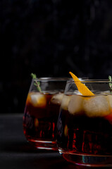 Two glasses of boulevardie cocktail on the black