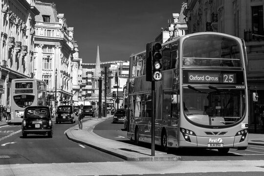 London, UK, April 1, 2012 : New modern Routemaster double decker red bus in New Oxford Street which is part of the cities public transport infrastructure, black and white monochrome stock photo image