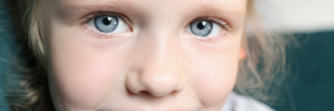 Little girl smiles and looks at camera. Children's developmental programs concept