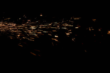 Glowing Flow of Sparks in the Dark. Fire sparks on a dark background