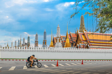 A biker man with Wat Phrakeaw (The Emerald Buddha temple) background  in Bangkok Thailand