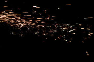 Glowing Flow of Sparks in the Dark. Fire sparks on a dark background