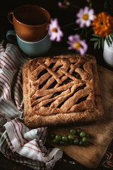 tea with pie. still life with cake and flowers on a wooden table. berries, and flowers on a brown wooden table. autumn still life with an appetizing cake and flowers on the kitchen