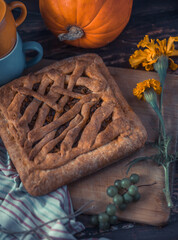 cookies and coffee. tea with herbs. still life with pumpkin. pie and herbal tea in an orange mug on a wooden table. berries, vegetables, flowers and tea on a brown wooden table. autumn still life with