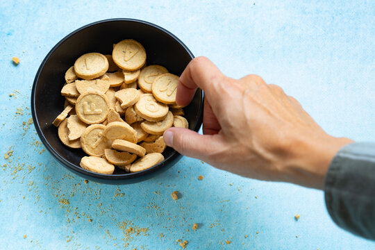 hand grabs round letter biscuit