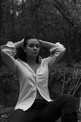 Girl in a white shirt in a dark forest