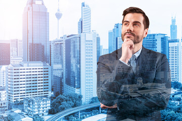 Young handsome businessman in suit with hand on chin thinking how to succeed, new career opportunities, MBA. Kuala Lumpur on background. Double exposure.