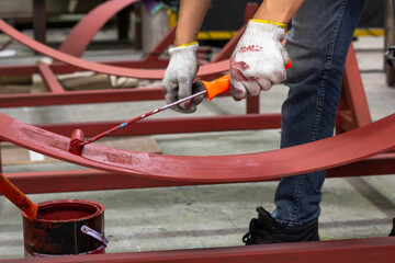 Rust-proof painted steel pipes in the factory. Red iron pipe