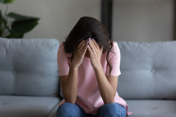 Depressed unhappy young arab mixed race woman feeling hopeless alone at home, suffering from psychological mental problems, relations breakup, betrayal or offend, abortion miscarriage concept.