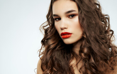 Fototapeta premium Pretty woman curly hair body care red lips close-up