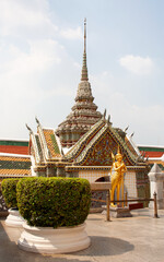 Fototapeta premium Golden statue of kinnara, mythical creature, in garden of Wat Phra Kaew temple within the Grand Palace complex, Bangkok, Thailand