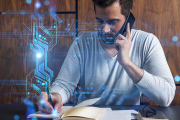 Handsome man talking phone and making notes at office workplace. Multiexposure. Tech information hologram.