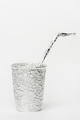Junk food concept, glass and straw made from foil