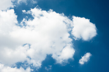 Blue sky over horizon and white clouds.