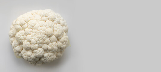 Fresh cauliflower on gray background with copy space. Top view, horizontal banner