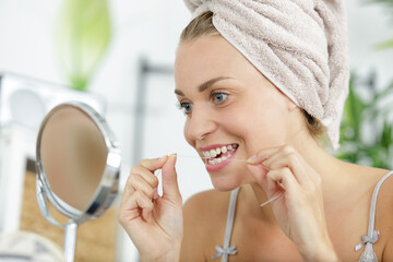 woman smile with tooth floss