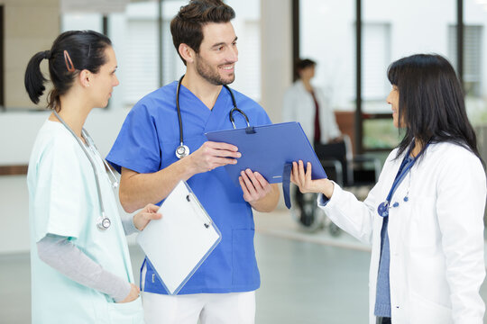 Staff In Busy Lobby Area Of Modern Hospital